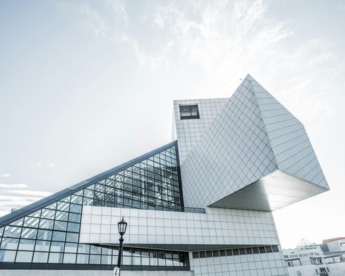 Geometry of Light: a white angular building against a bright sky